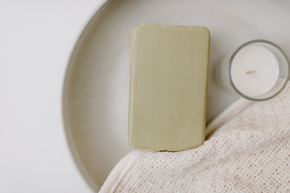 Minimalist image of a soap bar and candle on a tray, highlighting relaxation and self-care.