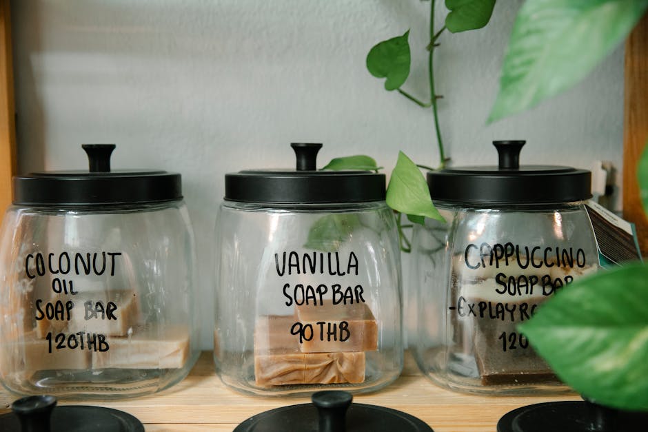 Image of eco-friendly handmade soap bars stored in transparent jars with labeled lids, promoting sustainability.